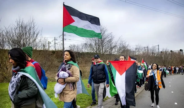 Participants attend a march from Leiden to the International Criminal Court in The Hague, in solidarity with Palestinians of the Gaza Strip, in Leiden, on 17 December, 2023 (AFP)