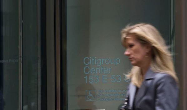 A woman walks out of the Citigroup center on Lexington Ave. on Friday, Nov. 14, 2008 in New York. (AP)