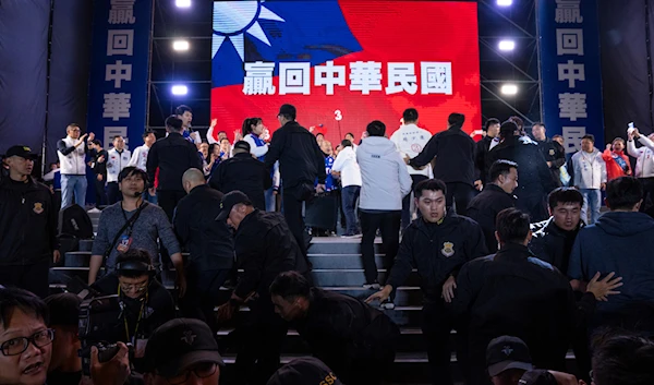 Security staff react after Kuomintang (KMT) presidential candidate Hou Yu-ih arrived at an election rally in New Taipei City, Taiwan on Friday, Jan. 12, 2024. (AP)