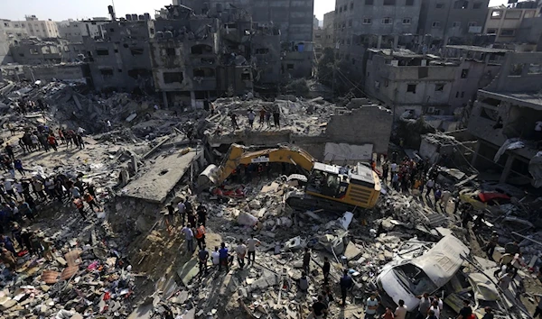 Palestinians look for survivors under the rubble of destroyed residential building following Israeli airstrikes in Jabaliya refugee camp, November 1, 2023. (AP)