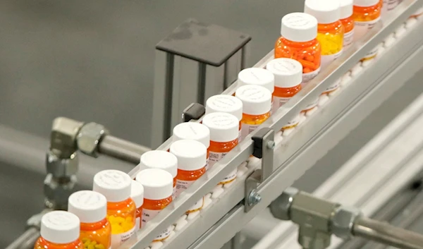 In this July 10, 2018 file photo, bottles of medications ride on a belt at a mail-in pharmacy warehouse in Florence, New Jersey (AP)