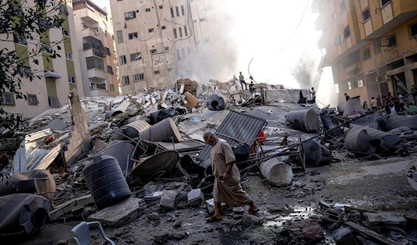 Palestinians inspect the rubble of a building after it was struck by an Israeli airstrike, in Gaza City, occupied Palestine, Saturday, Oct. 7, 2023. (AP)