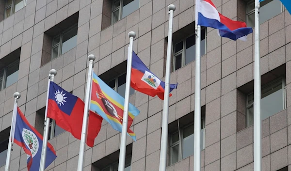 A pole, third from right, where Nauru national flag used to fly is vacant outside the Diplomatic Quarter building in Taipei, Taiwan, Monday, Jan. 15, 2024. (AP)