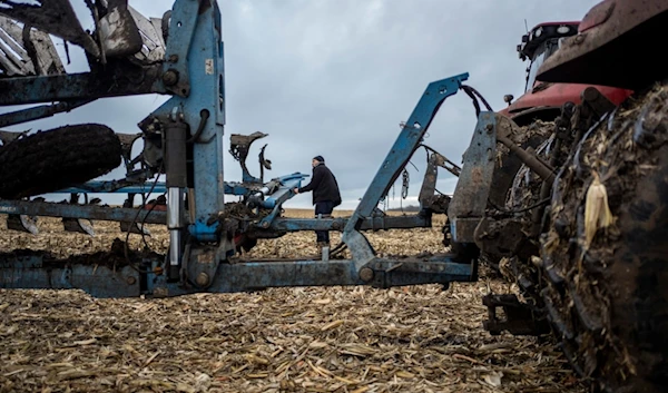 A farmer operates a tractor at a cornfield in Sumy region, Ukraine, on Friday, Nov. 24, 2023. (AP)