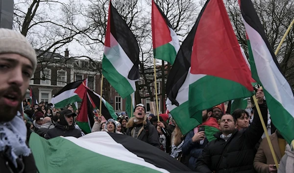 Protesters shout slogans outside the International Court of Justice in The Hague, Netherlands, Friday, Jan. 12, 2024. (AP)