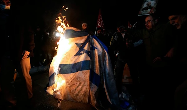 Iranian demonstrators burn an Israeli flag during a protest against the U.S. and British military strikes against Yemen, in front of the British Embassy in Tehran, Iran, Friday, Jan. 12, 2024. (AP)