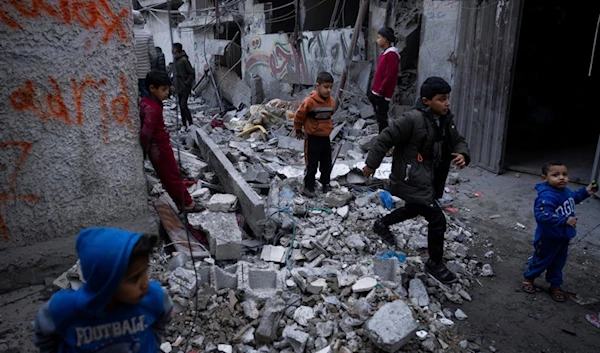 Palestinians look at the destruction after an Israeli strike in Rafah, southern Gaza Strip, Wednesday, Jan. 17, 2024. (AP)