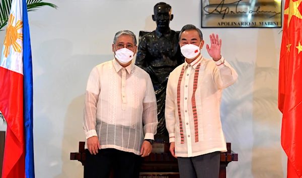 Philippine Foreign Affairs Secretary Enrique Manalo, left, and Chinese Foreign Minister Wang Yi pose for a photo before their bilateral talks at the Department of Foreign Affairs in Manila, Philippines on July 6, 2022. (AP)