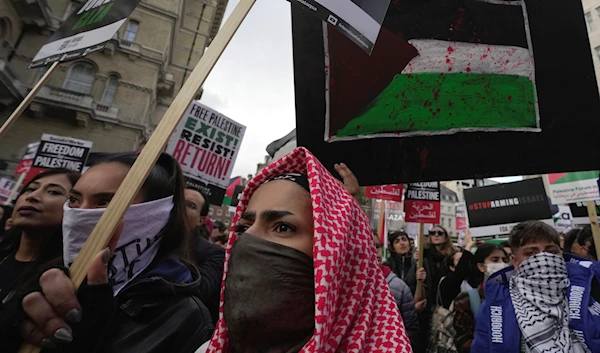 Protesters hold placards during a pro-Palestinian demonstration in London, Saturday, Oct. 14, 2023(AP)