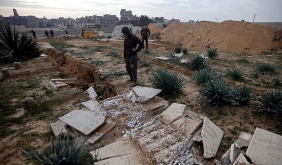 Palestinians inspect damaged graves following an Israeli raid over a cemetery in the Khan Younis refugee camp, southern Gaza Strip on Jan. 17, 2024. (AP)