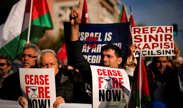 People shout slogans as they march in support of Palestinians during a protest calling for an immediate ceasefire in Gaza, in Istanbul, Turkey, Sunday, Jan. 14, 2024. (AP)