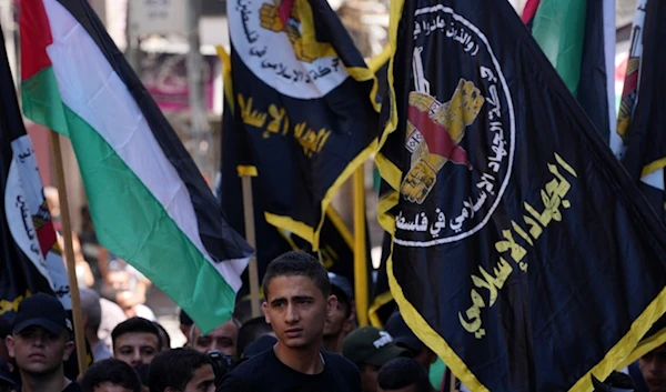 Palestinian Islamic Jihad supporters wave their movement and national flags during a protest in support of the Resistance in Gaza City, Friday, Aug. 4, 2023. Arabic on flags reads: 'Islamic Jihad'. (AP)