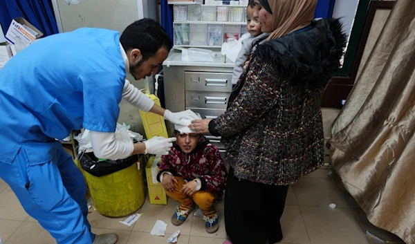 A Palestinian child wounded in an Israeli airstrike is brought to Al Aqsa Hospital in Deir al Balah, Gaza Strip, occupied Palestine, on Thursday, Jan. 11, 2024. (AP)