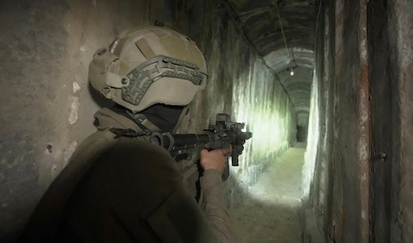 An Israeli soldier in an underground tunnel alleged to be under Shifa Hospital in Gaza City, Nov. 22, 2023 (AP)