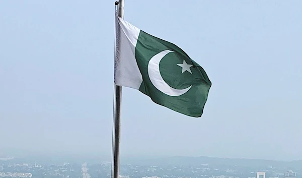 A Pakistani flag flies on a lookout in Islamabad, Pakistan, on July 27, 2022 (AP)