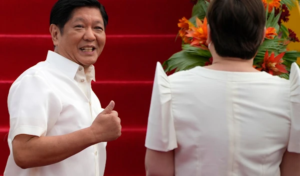 Philippine President Ferdinand Marcos Jr., gestures to Vice-President Sara Duterte as he boards a plane for China on Tuesday, Jan. 3, 2023, at the Villamor Air Base in Manila, Philippines.(AP)