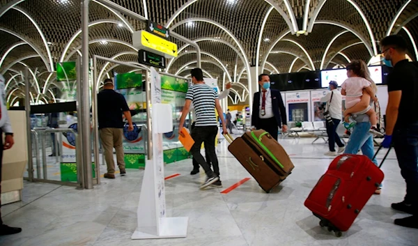 Passengers prepare to travel at the Baghdad Airport, in Baghdad, Iraq, Thursday, July, 23, 2020. (AP)