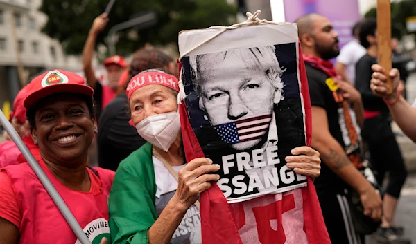 A demonstrator with a sign of Julian Assange protests his extradition to the U.S. during a march "The scream of the excluded" on Independence Day in Rio de Janeiro, Brazil, Thursday, Sept. 7, 2023(AP)