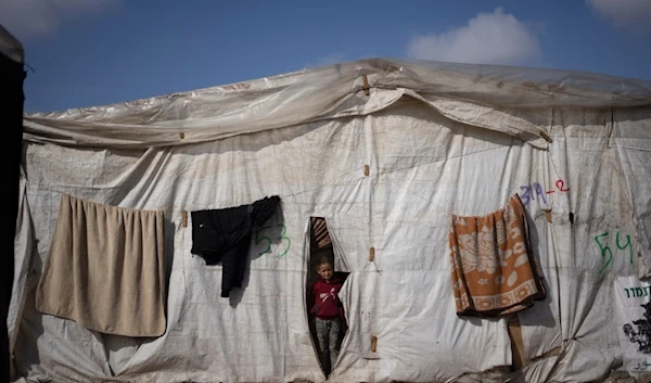 A Palestinian girl, displaced by the Israeli ground invasion against the Gaza Strip is seen at the makeshift tent camp in Rafah on Tuesday, Jan. 23, 2024 (AP)