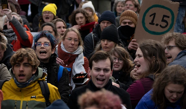 Activists, some from Extinction Rebellion shout slogans against global warming when blocking a busy road in The Hague, Netherlands, Jan. 28, 2023.(AP)