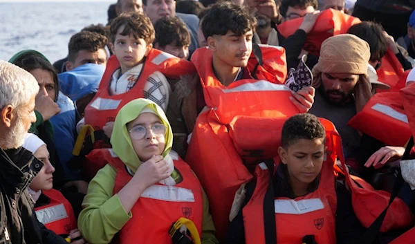 Migrants wear life vests as they are rescued by a MSF (Medecins Sans Frontiers) rescue team boat, after leaving Libya trying to reach European soil, in the Mediterranean Sea, Friday, Oct. 6, 2023. (AP)