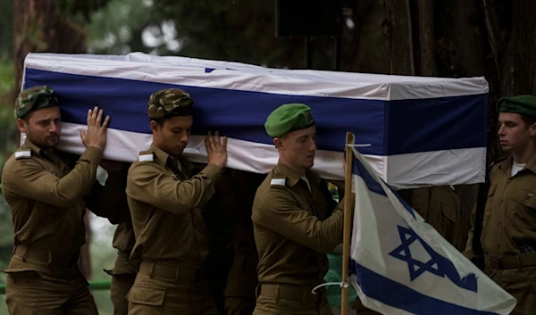 Israeli occupation soldiers carry the flag-draped casket of reservist Sgt. first class Nicholas Berger during his funeral at Mt. Herzl military cemetery in Occupied Al Quds, Occupied Palestine, Wednesday, Jan. 24, 2024 (AP)