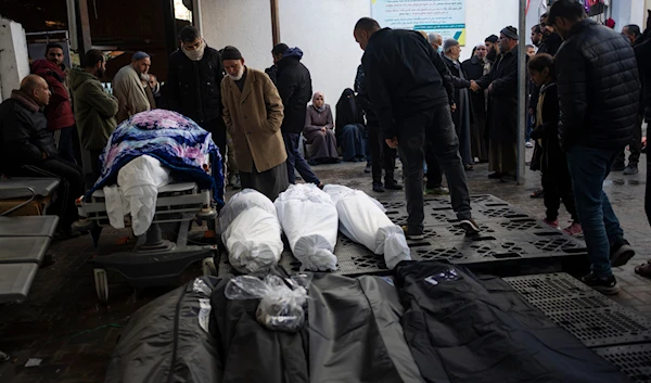 Palestinians gather around the bodies of martyrs who were killed by the Israeli ground  bombardment of Khan Younis, outside a morgue in Rafah, southern Gaza, Wednesday, Jan. 24, 2024(AP)