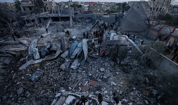 Palestinians look at a mosque destroyed in an Israeli strike in Rafah, Gaza Strip Wednesday, Jan. 24, 2024. (AP Photo/Fatima Shbair)