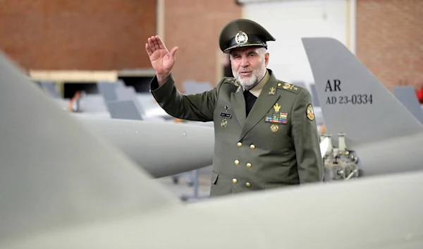 In this picture released by the official website of the Iranian Army, on April 20, 2023, commander of the Iranian Army's Ground Force Gen. Kioumars Heidari waves among Iran-made drones. (AP)