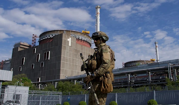 A Russian soldier patrols outside the Zaporizhzhia Nuclear Power Plant in Ukraine on May 1, 2022. (AFP)