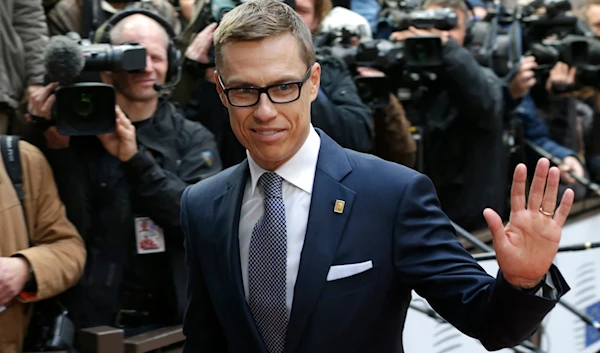 Finland's Prime Minister Alexander Stubb waves to the media upon arrival on the second day of an EU summit in Brussels, on Friday, Oct. 24, 2014. (AP)