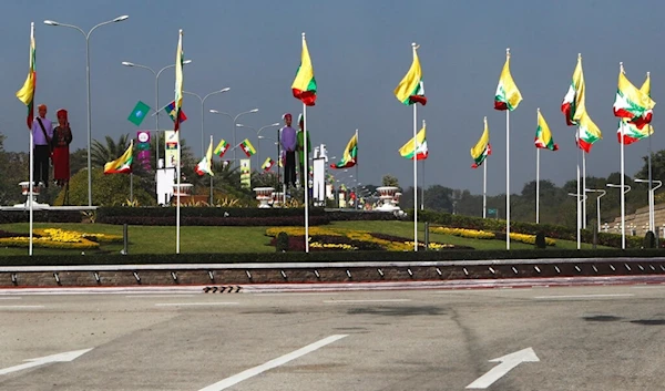 National flags line the a traffic circle ahead of Saturday's 75th Union Day, Friday, Feb. 11. 2022, in Naypyitaw, Myanmar. (AP Photo)