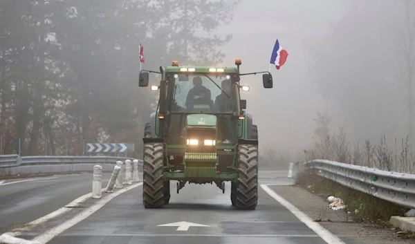 A farmer drives his tractor on a highway, near Agen, southwestern France, Saturday, Jan. 27, 2024. (AP)