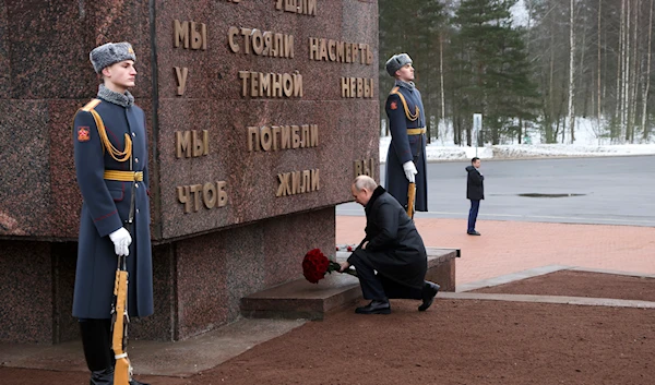 Russian President Vladimir Putin places flowers on a monument at Nevsky Pyatachok near Kirovsk, Russia, January 27, 2024 (AP)