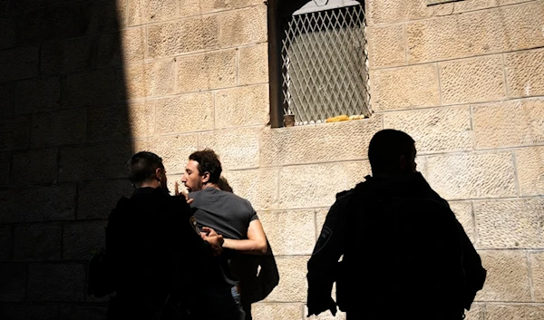 Israeli police detain a Palestinian worshipper ahead of Friday prayers at the Al-Aqsa Mosque compound in occupied al-Quds, Friday, Oct. 13, 2023 (AP)