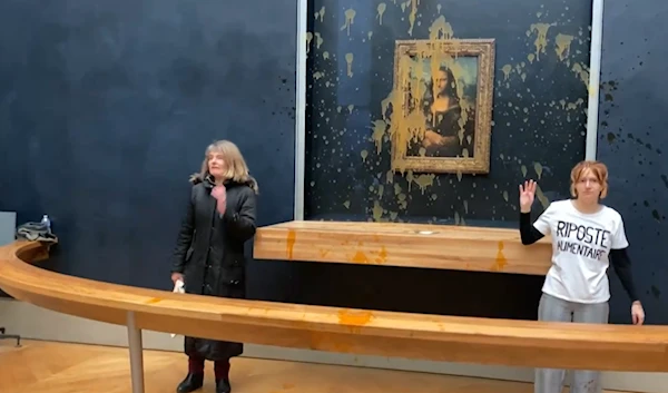 Two eco-activists throwing soup at the Mona Lisa in the Louvre (Screengrab from video posted on X)