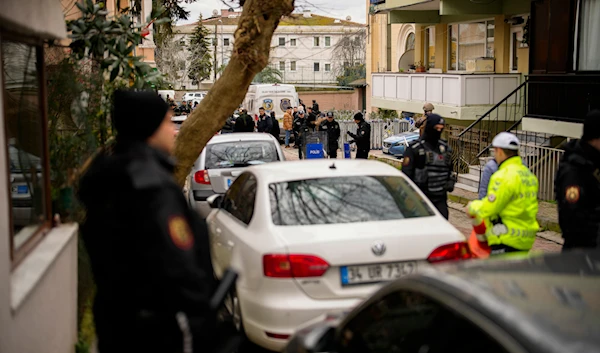 Turkish police officers stand guard on a cordoned-off area outside Santa Maria church in Istanbul, Turkey, January 28, 2024, after an attack (AP)