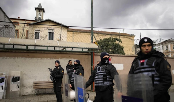 Turkish police officers stand guard in a cordoned off area outside the Santa Maria church, in Istanbul, Turkey on January 28, 2024. (AP)