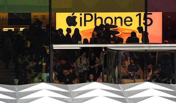 People visit an Apple Store to try out the latest iPhone 15 handsets, which have started its sale this week, at an outdoor shopping mall in Beijing, Sunday, Sept. 24, 2023. (AP)