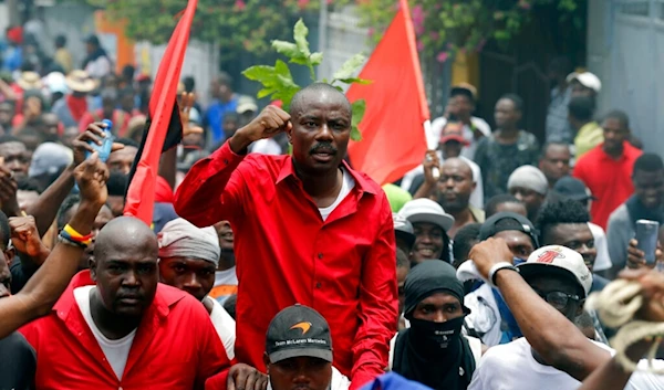 Former presidential candidate Moise Jean Charles chants anti-government slogans during a protest demanding the resignation of President Jovenel Moise in Port-au-Prince, Haiti, Sunday, June 9, 2019 (AP)