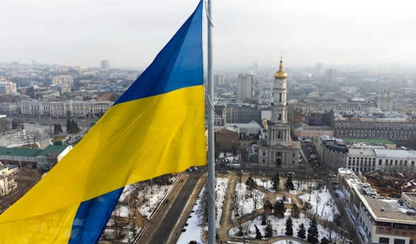 A Ukrainian national flag waves over the center of Kharkiv, Ukraine's second-largest city, Wednesday, Feb. 16, 2022. (AP)