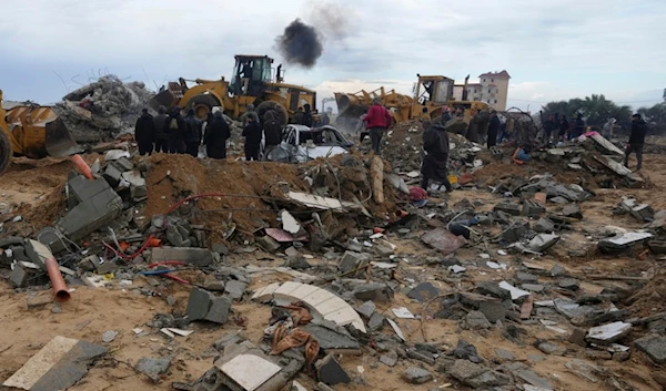 Palestinians search for the bodies after an Israeli strike in Zuweida, Gaza Strip, Monday, Jan. 29, 2024 (AP Photo/Adel Hana)