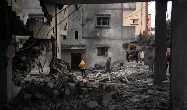 Palestinians look at the destruction after an Israeli strike in Rafah, southern Gaza Strip, Wednesday, Jan. 3, 2024 (AP)