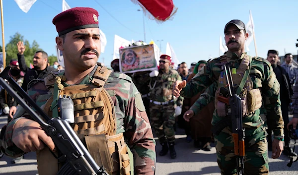 Members of an Iraqi Resistance faction group carry the coffin of a Kataib Hezbollah fighter who was killed in a US airstrike in Babil Province, during his funeral in Baghdad, Iraq, December 26, 2023 (AP)