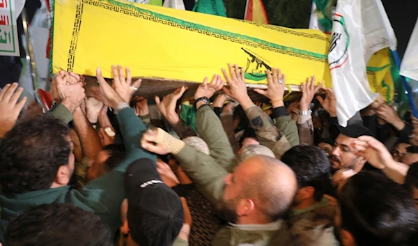 Members of an Iraqi PMF carry the coffin of the funeral of an official who was killed in a U.S. airstrike Province, in Baghdad, Iraq, Thursday, Jan. 4, 2024 (AP Photo/Hadi Mizban)