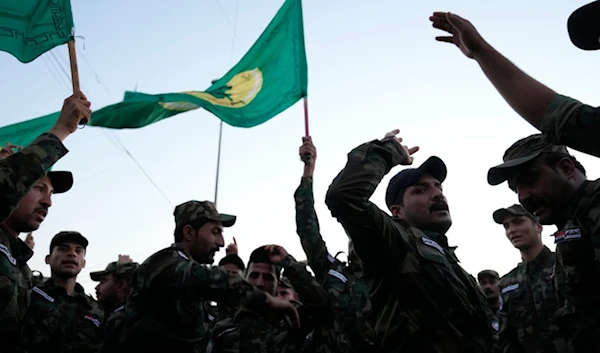 Iraqi resistance fighters attend the funeral of a leader who was killed by US occupation forces, in Baghdad, Iraq, Thursday, Jan. 4, 2024. (AP)