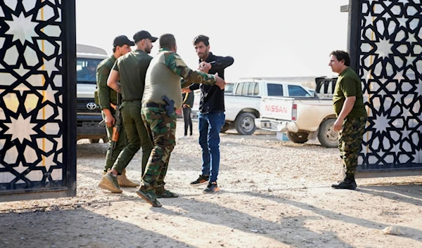 Members of the PMF stand outside the headquarters of the Popular Mobilization Force after it was hit by an airstrike in Baghdad, Iraq, Thursday, Jan. 4, 2024 (AP Photo/Hadi Mizban)