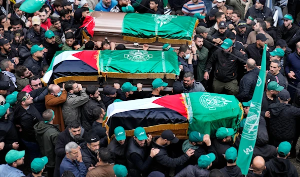 Mourners carry the coffins of Hamas deputy chief Saleh al-Arouri and two other Hamas members, who were killed in an Israeli strike Tuesday, during their funeral in Beirut, Lebanon, January 4, 2024 (AP)