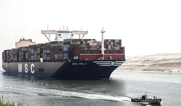 A container ship passes through Suez Canal, Egypt, Tuesday, April 6, 2021. (AP)