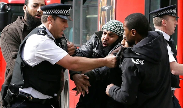 Demonstrators clash with police officers outside The Royal Courts of Justice in London Friday, Oct. 5, 2012 (AP)